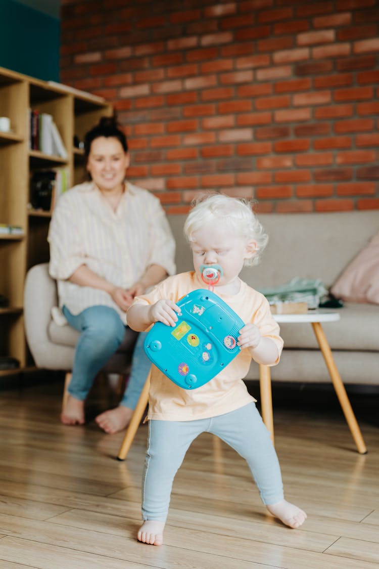 A Cute Baby Playing Alone With Her Toy 