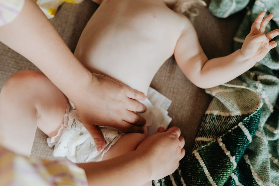 Free Hands Putting On Diaper on Baby Stock Photo