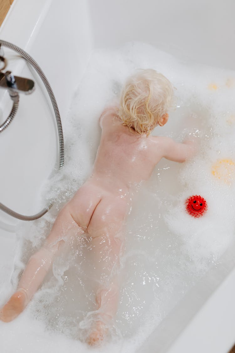 High-Angle Shot Of A Naked Baby In The Bathtub