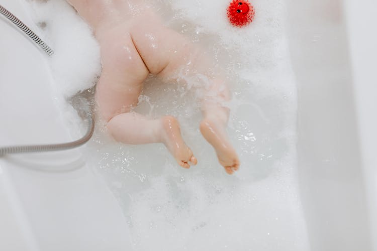 Baby Lying Down In Bathtub