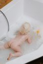 Blonde Haired Baby on White Bathtub