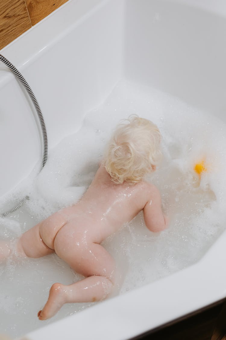 High-Angle Shot Of A Naked Baby In The Bathtub