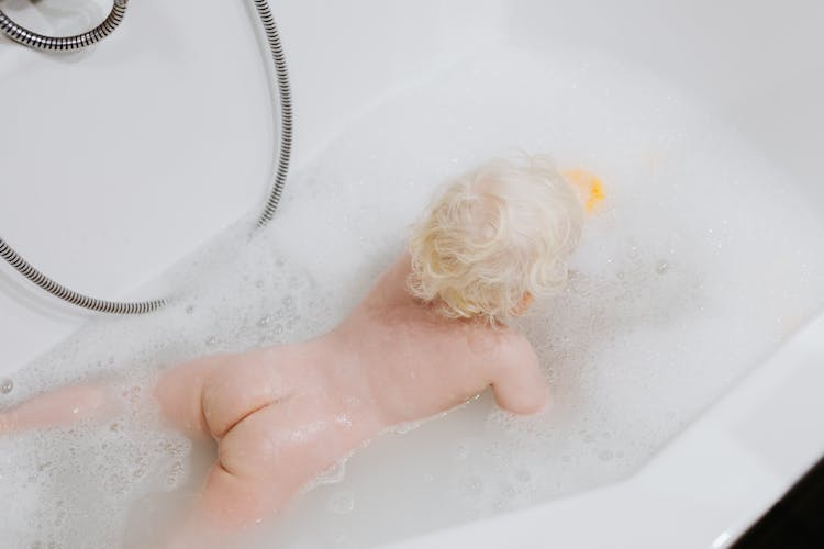 High-Angle Shot Of A Naked Baby In The Bathtub