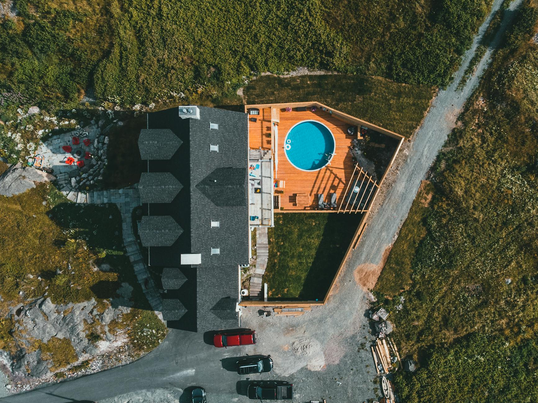 Aerial View of Secluded Mansion with Pool on Wooden Deck