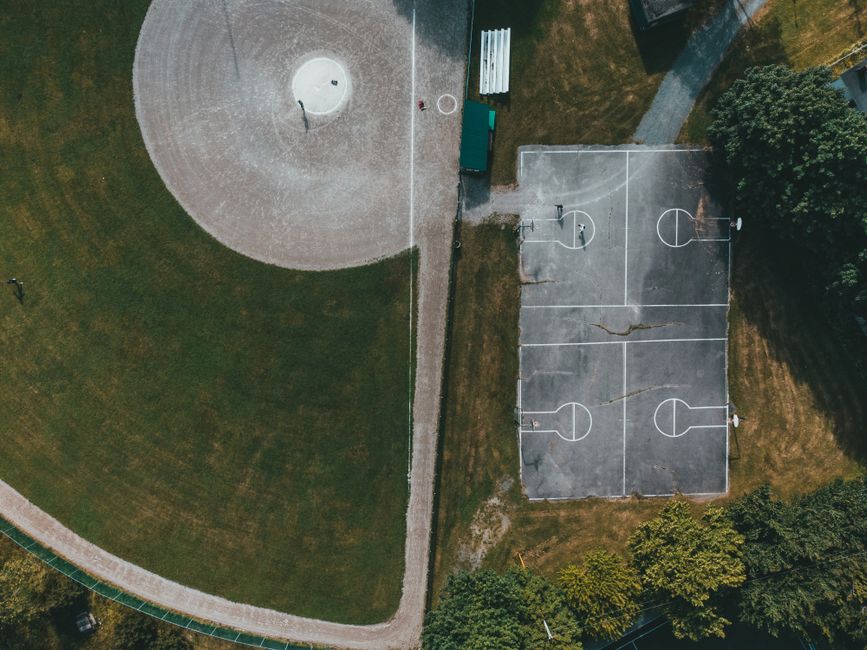 Aerial view of a dog park nestled within a modern city neighborhood - apartments for rent that are pet friendly Aerial view of a dog park nestled within a modern city neighborhood - apartments for rent that are pet friendly
