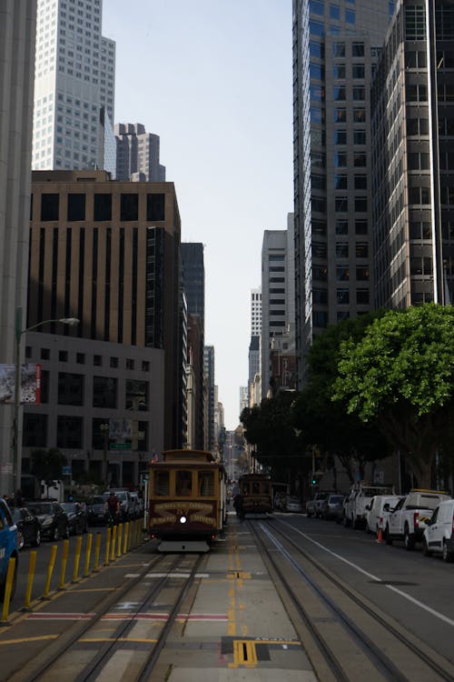 Free Cable Cars on Road Near High Rise Buildings Stock Photo