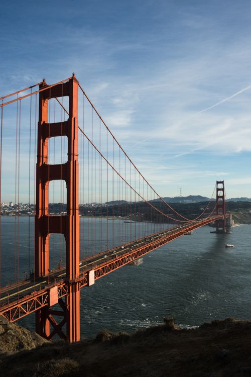 Free Iconic Golden Gate Bridge spanning San Francisco Bay under bright, clear skies. Stock Photo