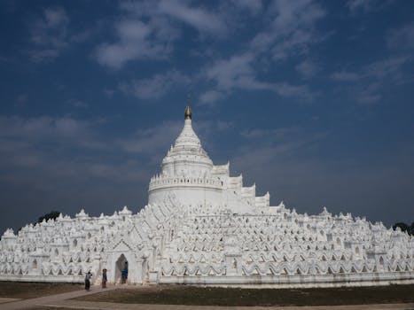 A breathtaking view of the white Hsinbyume Pagoda under blue skies in Mingun, Myanmar.