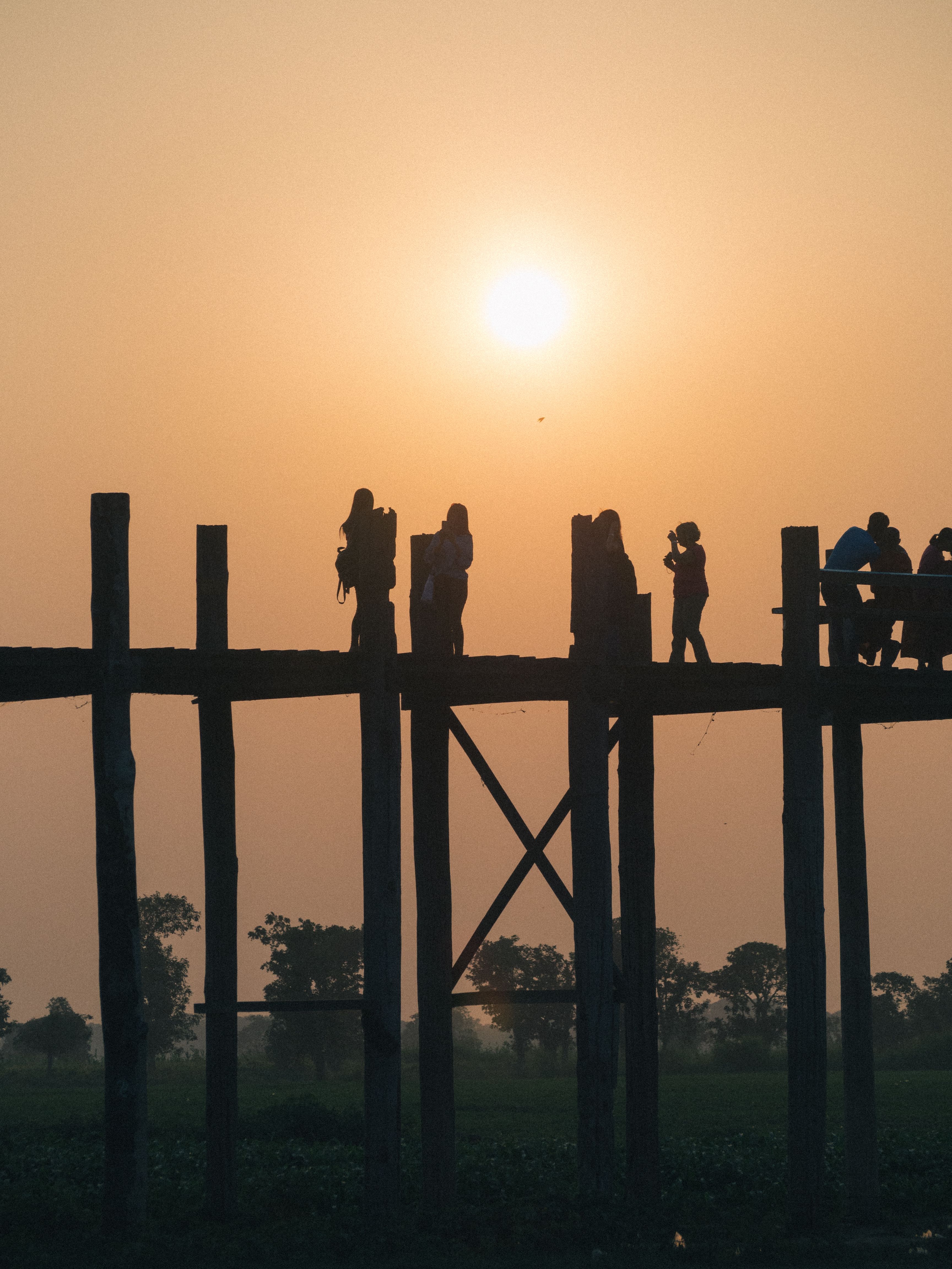 Silhouette of People Walking on a Wooden Bridge · Free Stock Photo