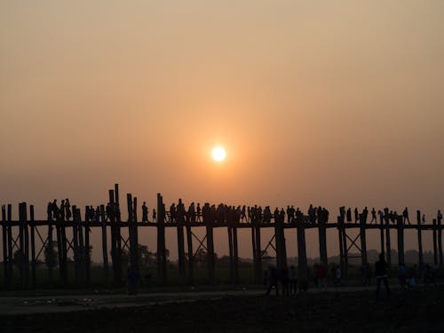 Free Silhouette of People on A Wooden Bridge During Sunset Stock Photo