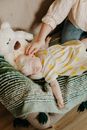 Adult Hand Touching Baby Sleeping on Sofa