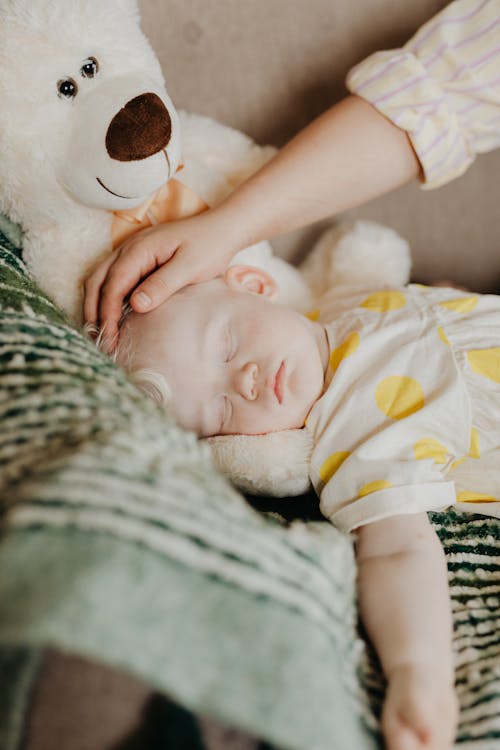 Free Adult Hand on Babys Head Stock Photo