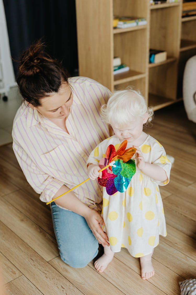 A Young Girl Playing A Pinwheel