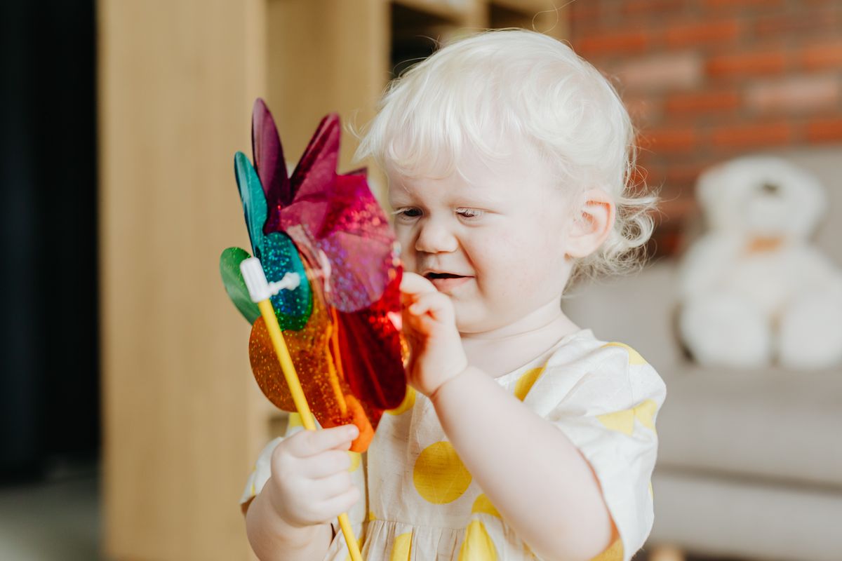 Child holding a toy windmill