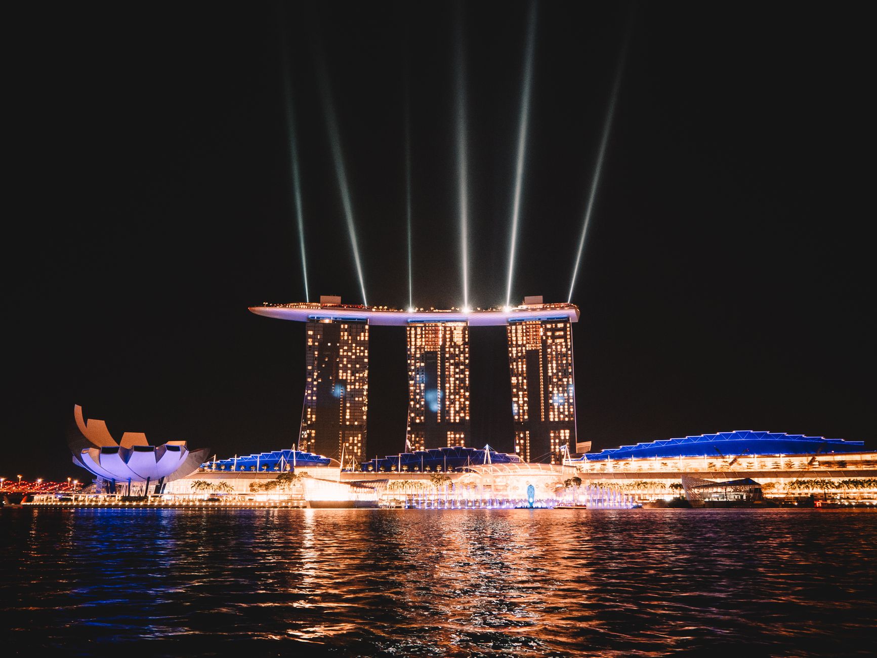 Stunning night view of Marina Bay Sands with dazzling lights reflected on the water in Singapore.