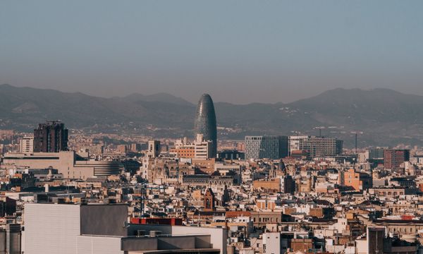 A panoramic view of Barcelona's skyline with Torre Glòries during a clear morning.