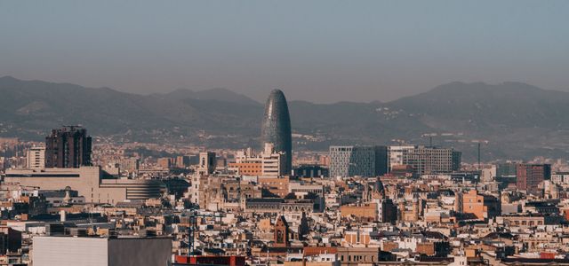A panoramic view of Barcelona's skyline with Torre Glòries during a clear morning.