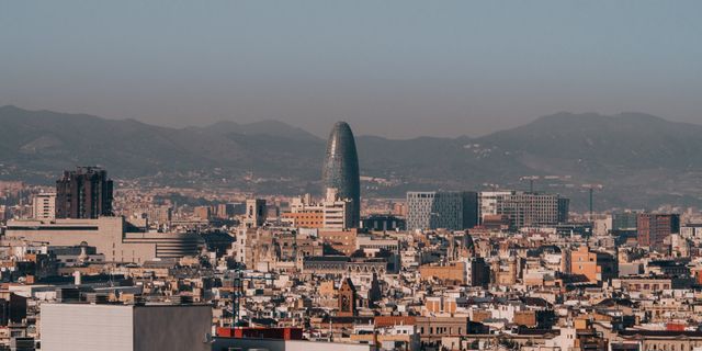 A panoramic view of Barcelona's skyline with Torre Glòries during a clear morning.