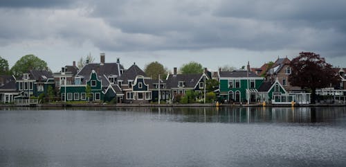 Houses on River Side Under the Cloudy Sky