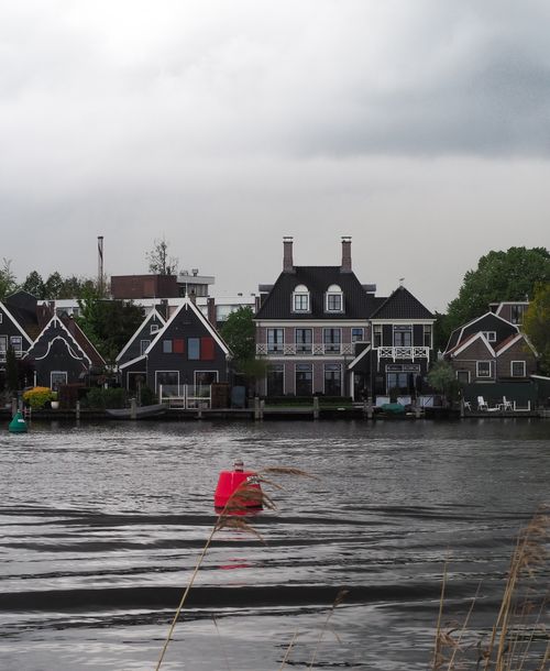 Free Scenic view of traditional Dutch houses along a canal, showcasing charming architecture and serene water reflections. Stock Photo