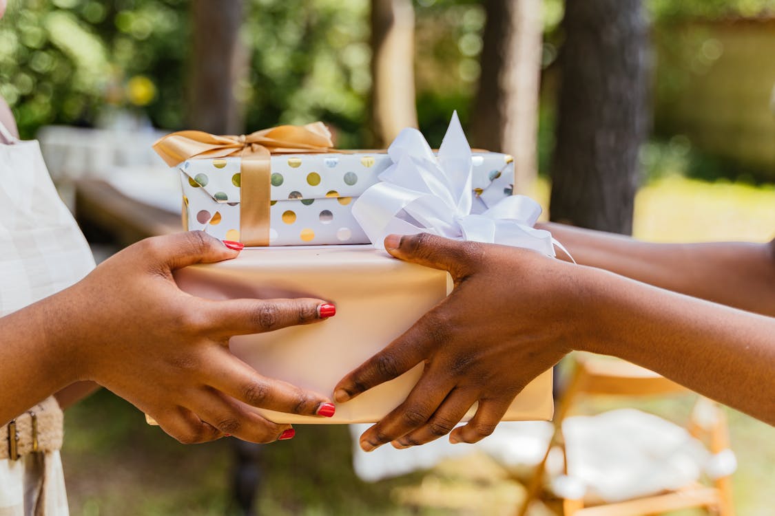 Free Hands Giving and Receiving Wrapped Presents Stock Photo
