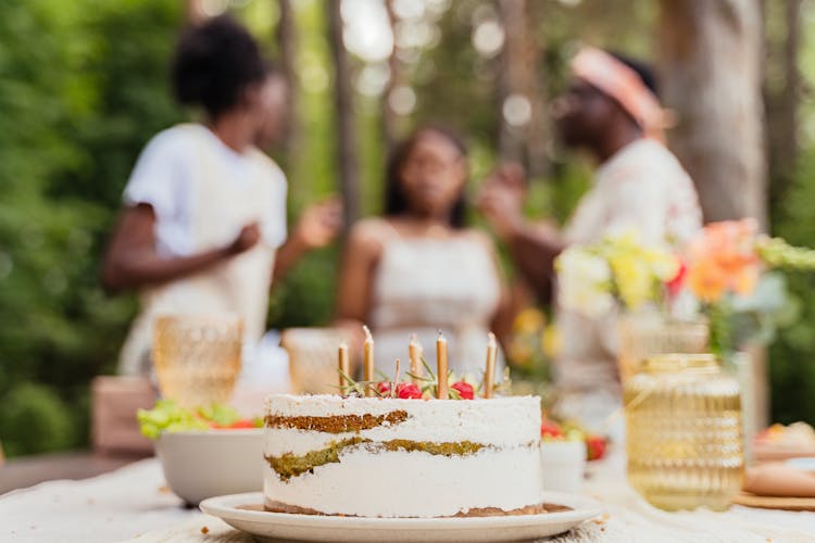 A Birthday Cake With Candles Over A Table