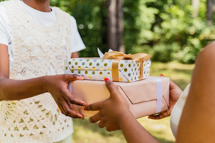 Person Giving Gifts To Another Person