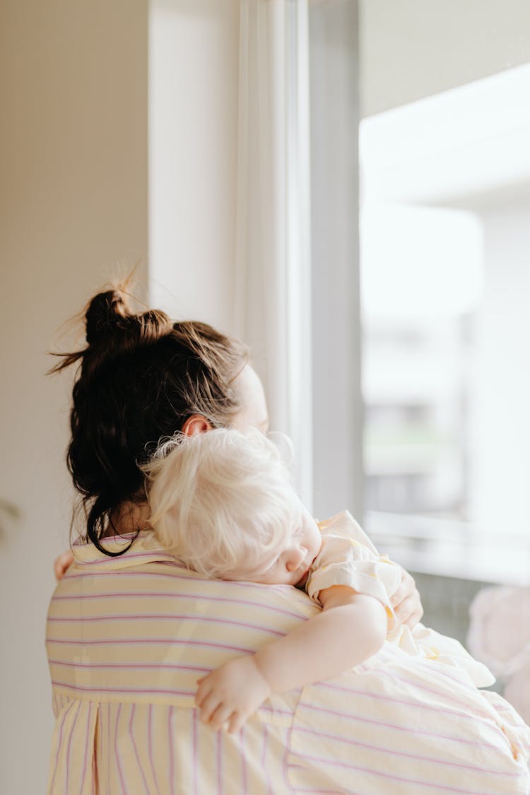 Woman Carrying Her Baby