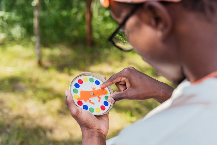 Man Playing With Twister Spinning Wheel