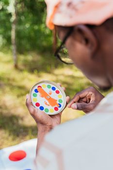 A man enjoying an outdoor leisure activity with a colorful toy in hand.