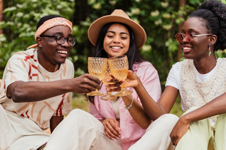 People Having Fun And Tasting Glasses On Garden Party