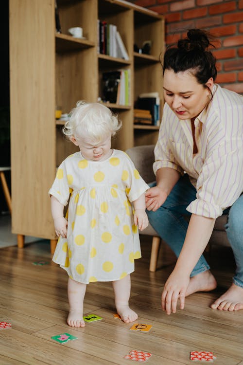 Girl in Sundress and Mother Playing with Cards on Floor