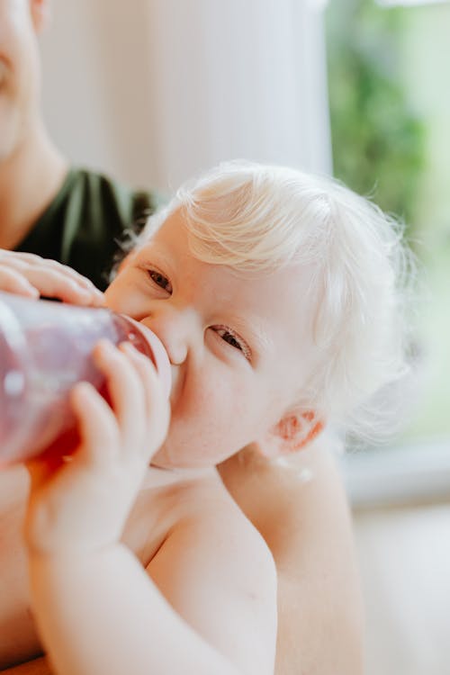 Blonde Baby Drinking from Bottle