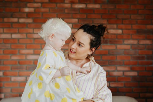 A Woman Carrying a Young Girl