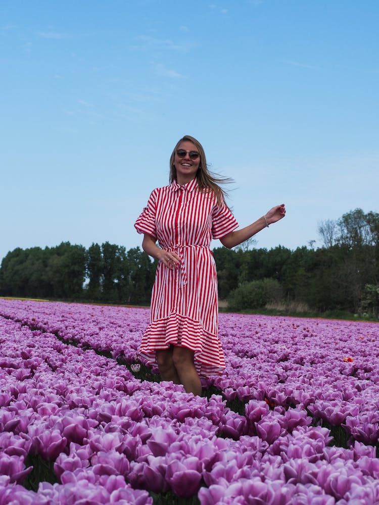 Woman In Dress Posing In Tulips Field