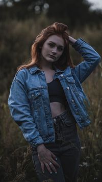 Woman in a denim jacket in a field at dusk, by NIKITA POLYAKOV on Pexels