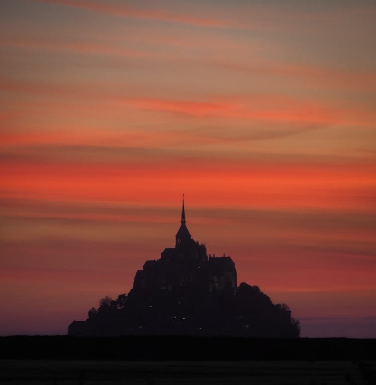 Silhouette Of An Abbey In An Island During Sunset