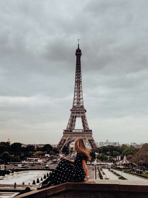 Free A Photo of a Woman Posing in Front of Eiffel Tower Stock Photo
