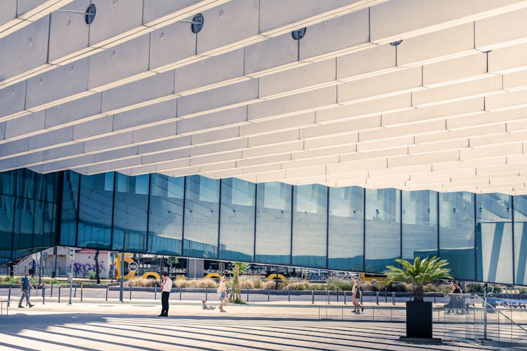 People Walking Near The EDP Headquarters In Lisboa Portugal