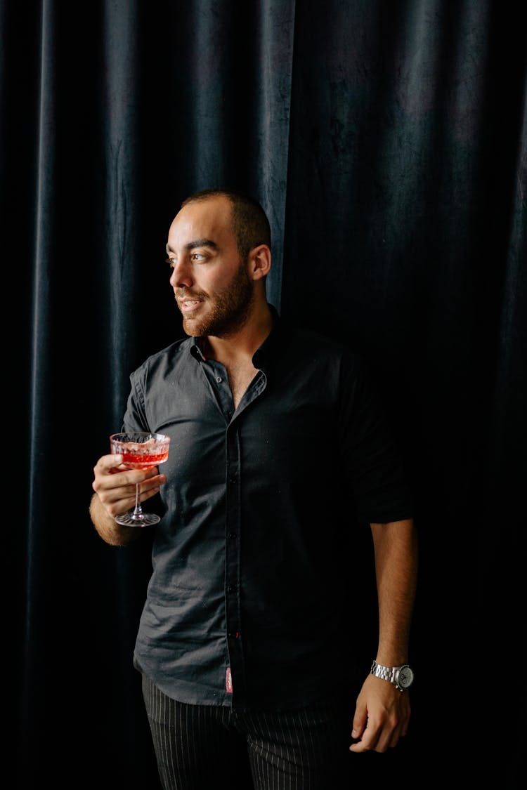 Man In Black Polo Holding Clear Drinking Glass