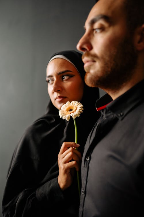 Portrait of Woman with Flower and Man in Shirt
