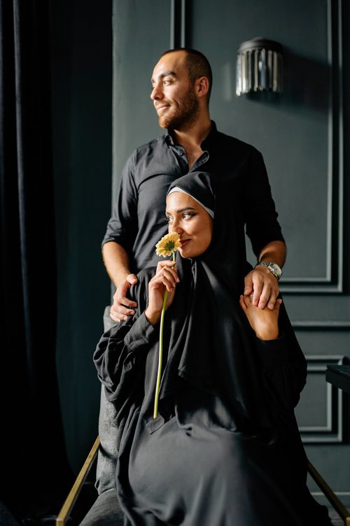 Free A thoughtful couple poses in a serene setting, embracing and sharing a moment of tranquility. Stock Photo