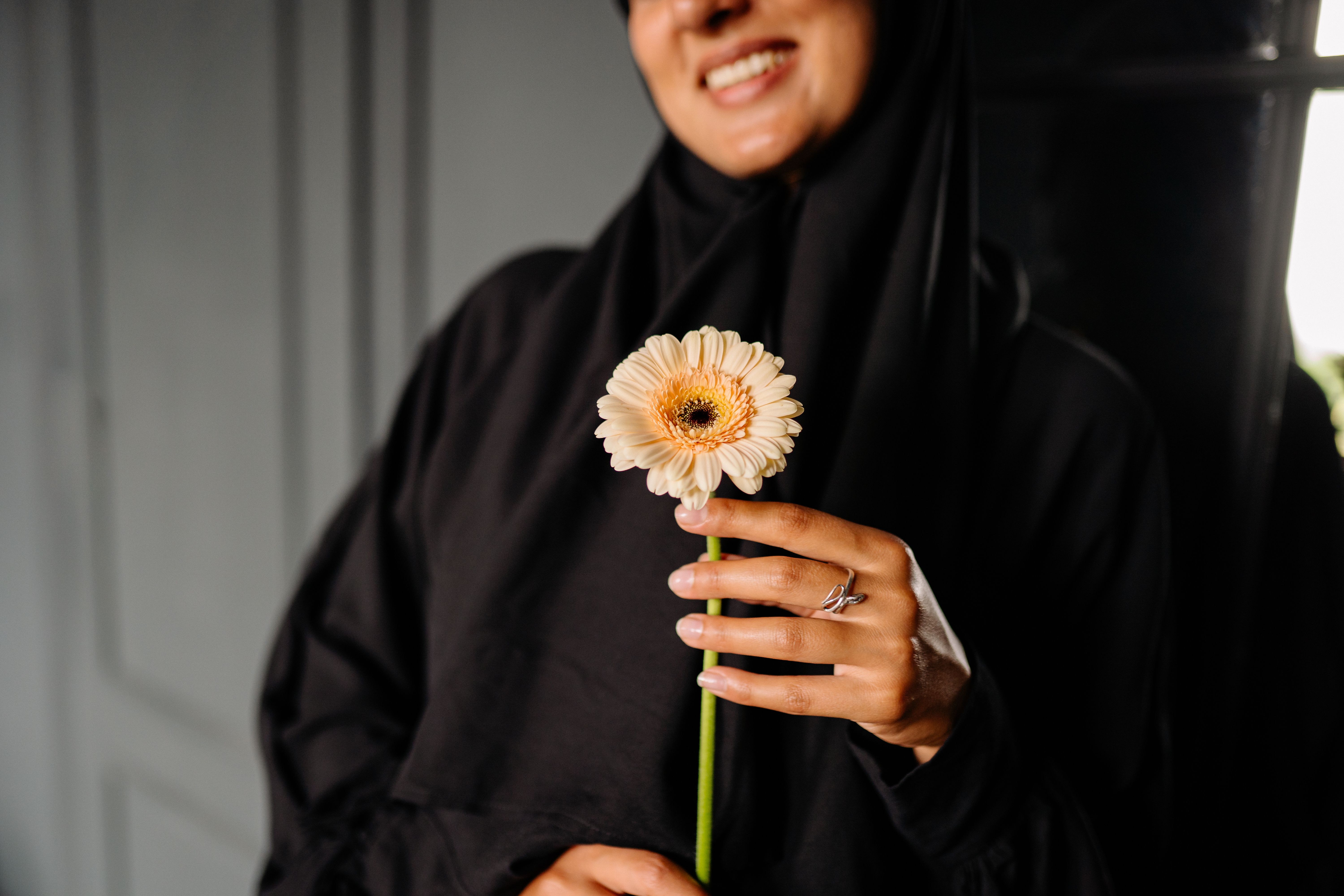 Woman in Black Dress Holding White and Yellow Flower · Free Stock Photo