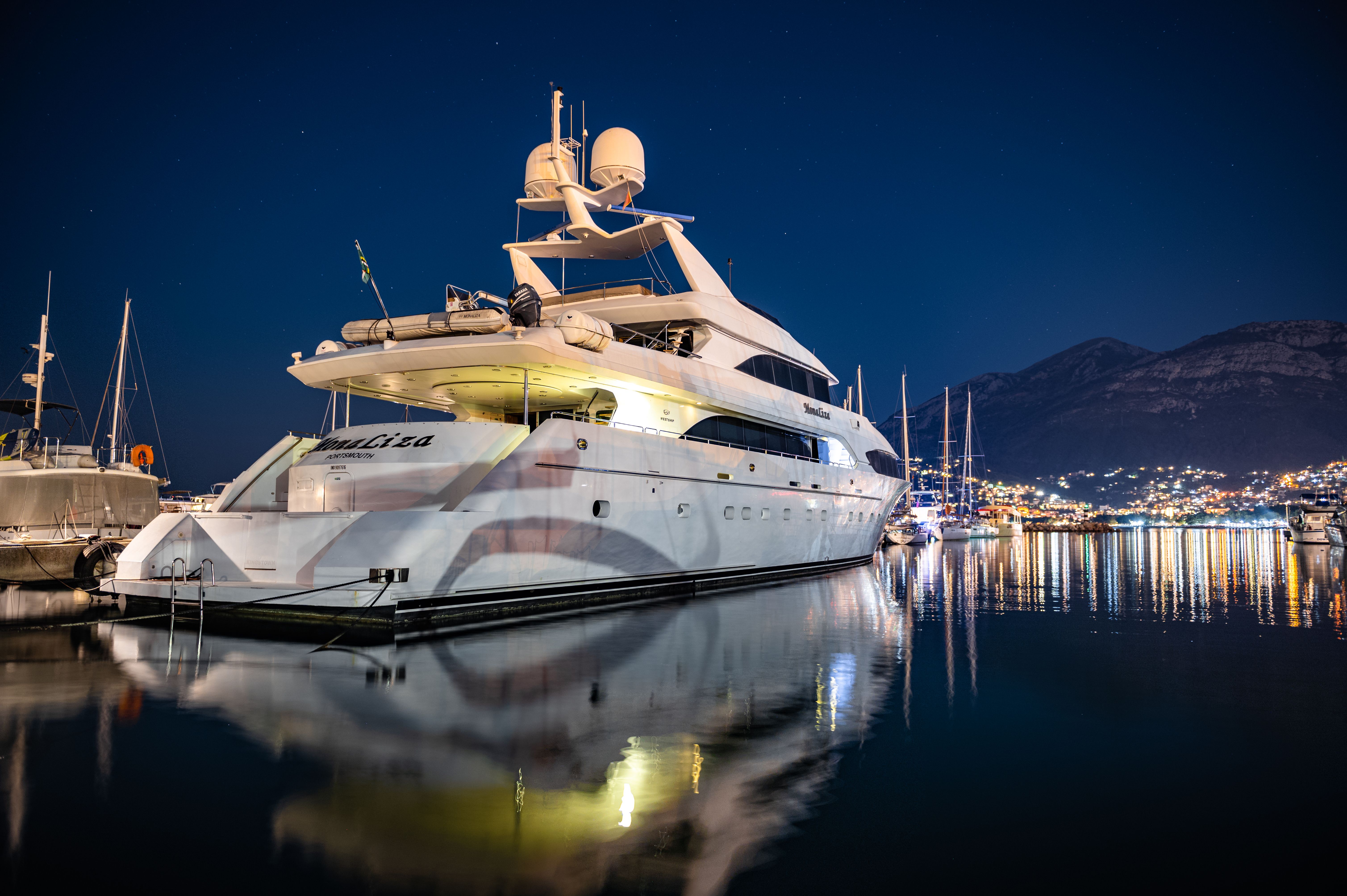 Yacht illuminated at night on the water