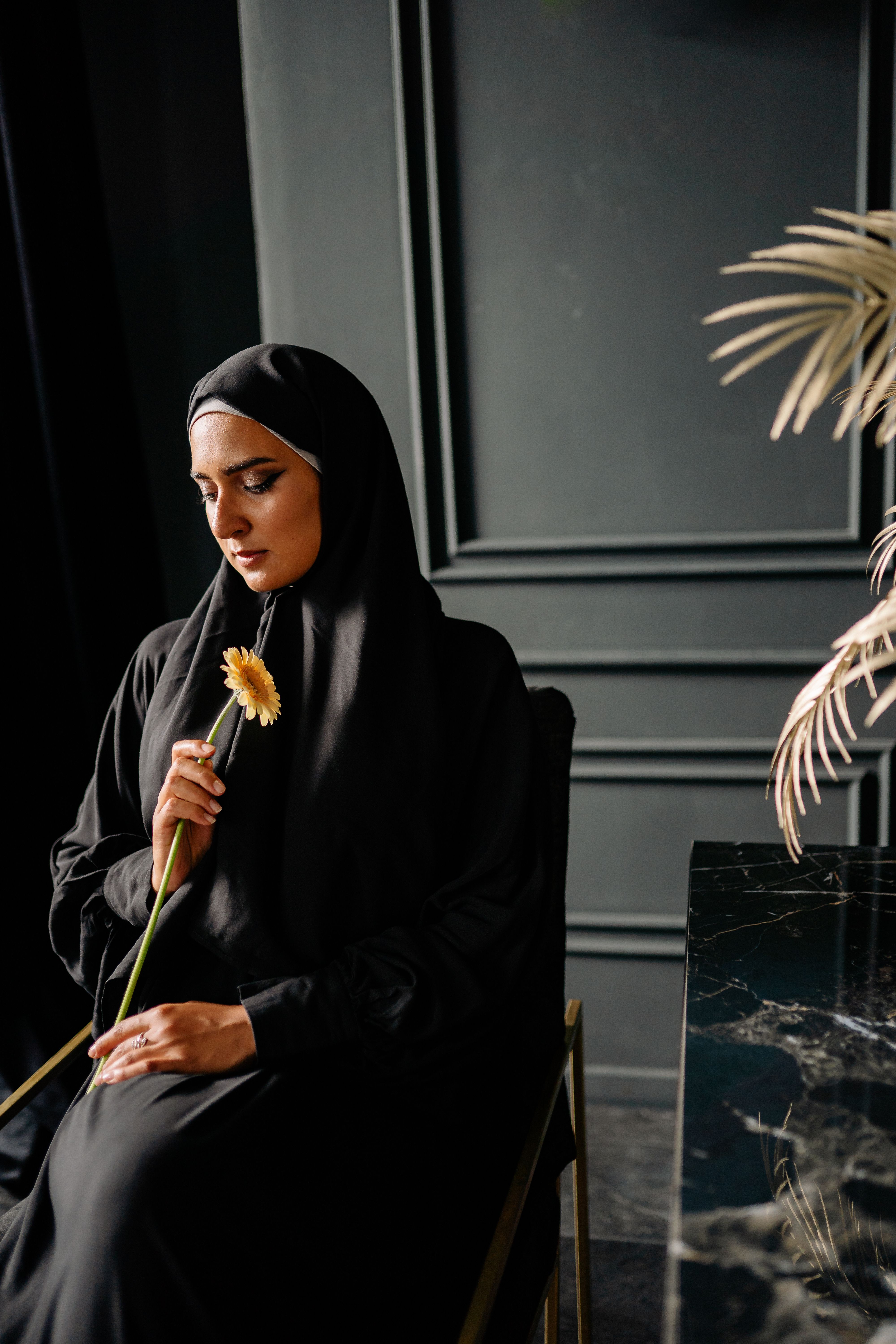 Woman in Black Hijab Holding White Daisy Flower · Free Stock Photo