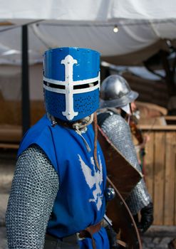 A knight in blue armor participates in a medieval festival in Leiria, Portugal, showcasing historical attire.