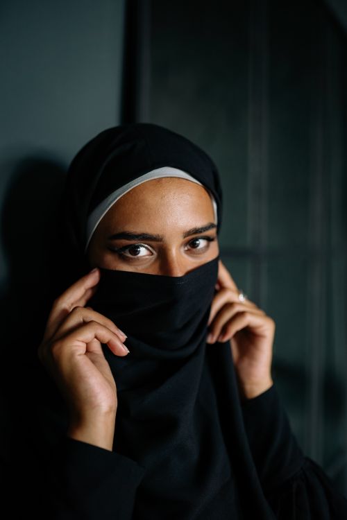 Free Elegant portrait of a woman wearing a black hijab, expressing confidence and grace through her eyes. Stock Photo