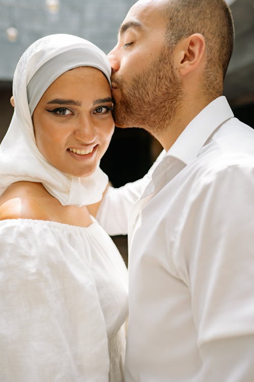 Man Kissing Woman in Hijab