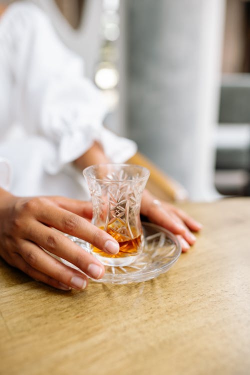 Woman Hands over Tea Glass