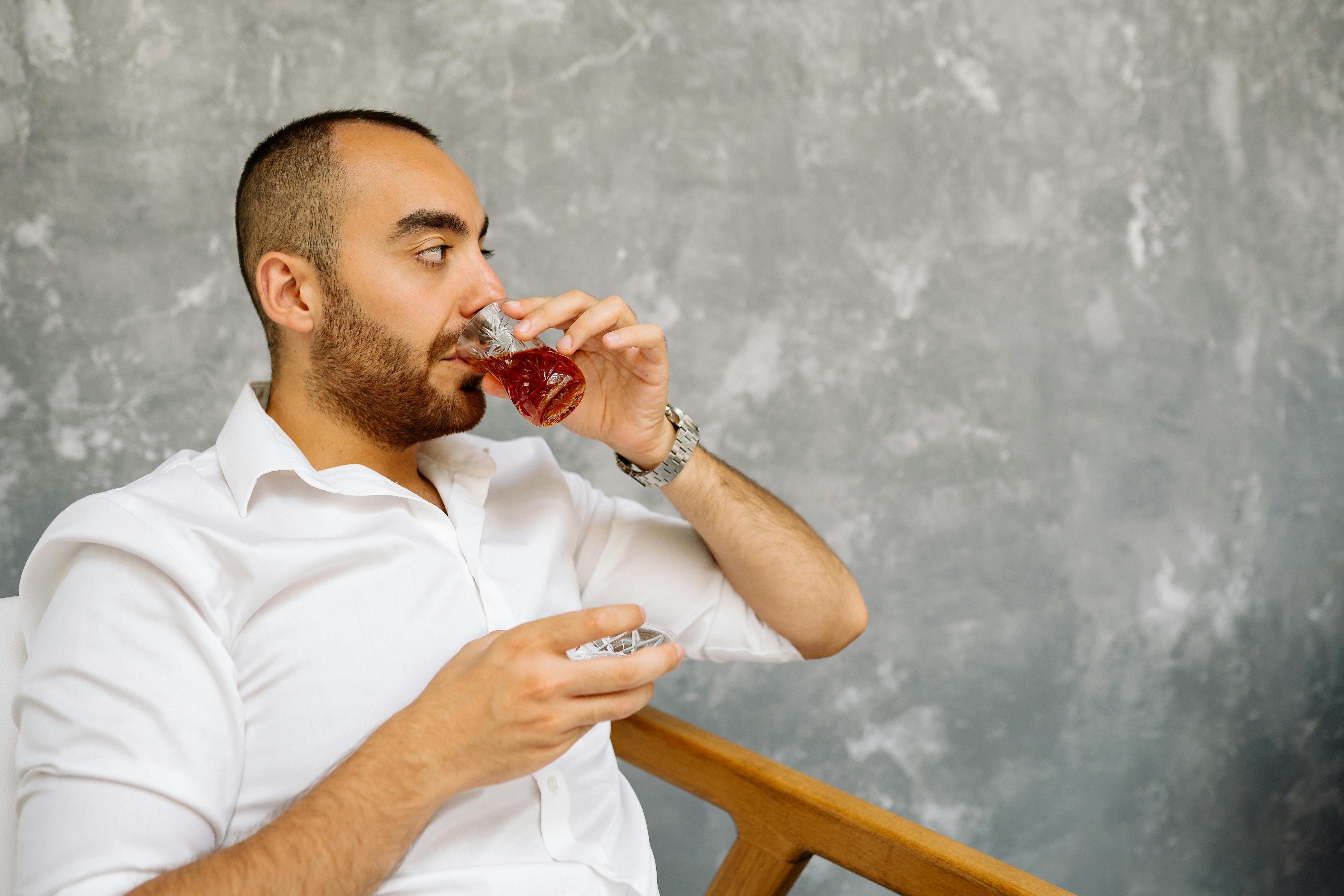A Man in Black Polo Shirt Drinking Beer · Free Stock Photo A Man in Black Polo Shirt Drinking Beer · Free Stock Photo